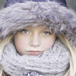 girl shows the face from covered scarf