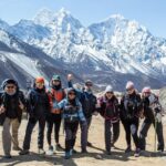 The climbers are infront of mountans