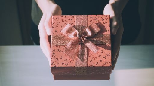 A gift box tied with ribbon is given