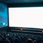 The large screen with full of audience in theatre