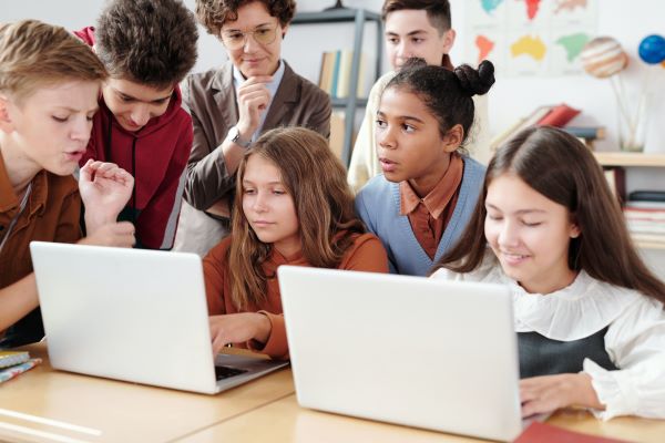 The students studying with the help of laptops