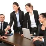 Woman shaking hands in office meet