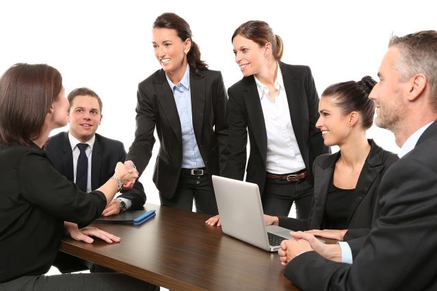 Woman shaking hands in office meet