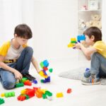 The boys playing with building blocks