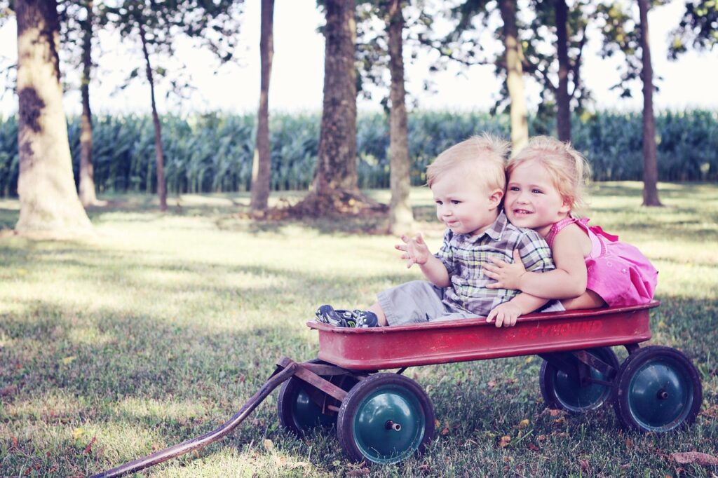 children playing in pulling cart