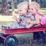 children playing in pulling cart
