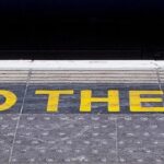 On the platform of railway station is reminds mind the gap